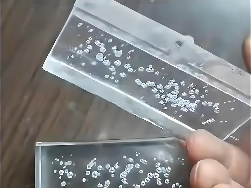 Cross-section of plastic part showing internal voids and bubbles